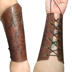 Brown leather arm cuff with intricate designs on a person's arm.