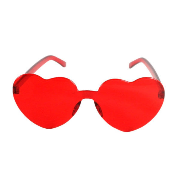 Heart-shaped red Perspex party glasses.  Description: These vibrant party glasses are crafted from red Perspex material, forming a whimsical heart shape. The transparent red colour adds a playful touch, making them the perfect accessory for festive occasions