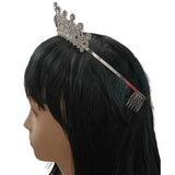 Side view of a Crystal Princess Tiara in silver, featuring rhinestone detailing and metal combs for secure placement, worn on a mannequin with a black wig, against a white background