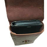 Deluxe medieval-style bag in brown with bronze-gold rivet details, open at the top to show a black mobile phone fitting inside, against a white background