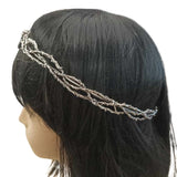 Side view of an Elven medieval fantasy crown with intricate metal textures and a silver finish, featuring a central gem, worn on a mannequin with a black wig, against a white background