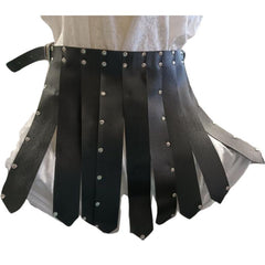 Black leather-look Roman skirt displayed on a mannequin, featuring multiple fabric strips, silver rivet details, and adjustable side belts for a historical warrior look.