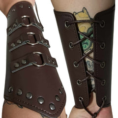 Side-by-side front and back views of brown Medieval Wrist Braces, laced up on a forearm. The front features three silver rings with silver rivets, while the back shows silver eyelets laced with brown cord