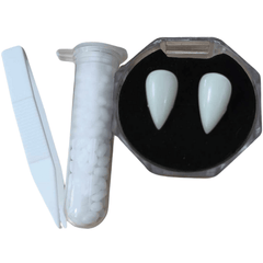 Set of two vampire teeth caps, accompanied by thermal fitting beads and small tweezers for customization, against a white background
