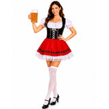 A woman modeling a traditional German dirndl costume against a plain white background. The costume features a black lace-up bodice with white puffed sleeves, a red skirt with white lace trim, white thigh-high stockings, and black Mary Jane heels.