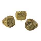 Three gold rings with intricate designs on a white background