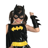 A young girl wearing a shiny black and yellow Batman costume, featuring a bat mask, a spiky black arm cuff, and a yellow utility belt, posed against a plain white background.