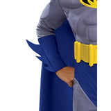 A close-up of a Batman costume worn by a person, showing the gray and blue fabric, yellow belt, and part of the cape on a plain white background.