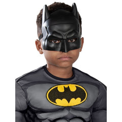 Child wearing an officially licensed Batman Premium costume with muscle chest, cape and mask