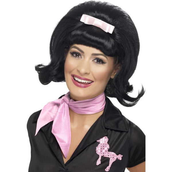 Black 1950's styled beehive wig with flicked ends, adorned with a cute pink bow for a retro look.