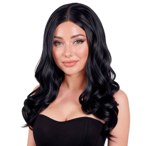 A woman modeling a long, wavy black wig against a plain white background.