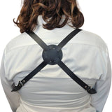 Person wearing a black shoulder holster on a white background