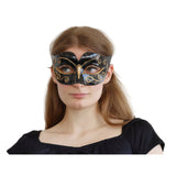 Woman wearing a black and gold decorative mask 