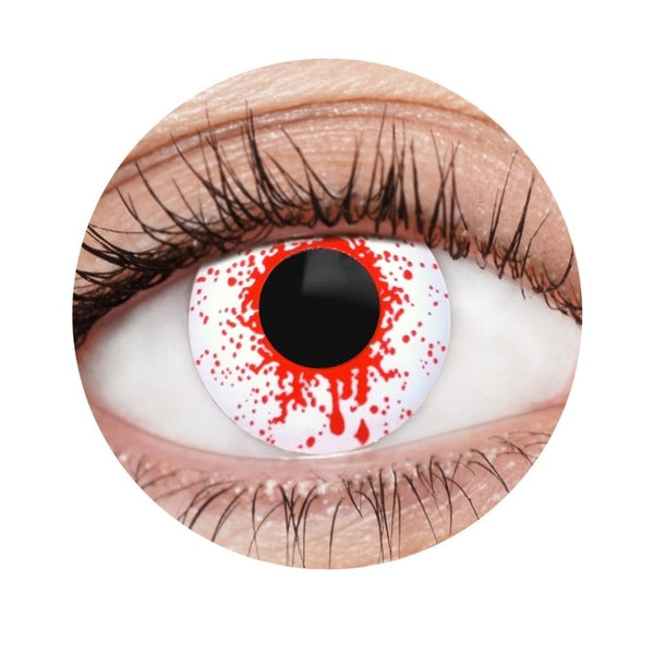 Close-up of a colored contact lens with red and white design on a white background