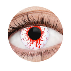 Close-up of a colored contact lens with red and white design on a white background