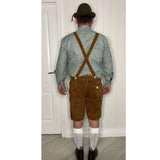 Back view of brown leather lederhosen show crossed braces and adjustable waist placket.