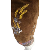Embroidery detail on pant leg of the brown leather lederhosen