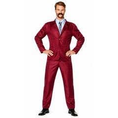 Adult wearing burgundy newsreader suit with tie and retro 70s television presenter styling