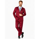 Man wearing burgundy retro suit costume with moustache in classic newsreader pose