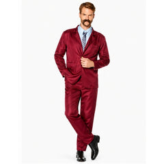 Adult wearing burgundy newsreader suit with tie and retro 70s television presenter styling
