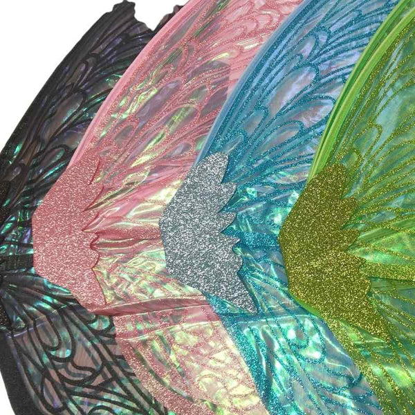 Close-up of iridescent glitter angel wings in multiple colors, including pink, blue, green, and silver, with black lace-like detailing.