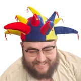 Person wearing a colorful jester hat on a white background