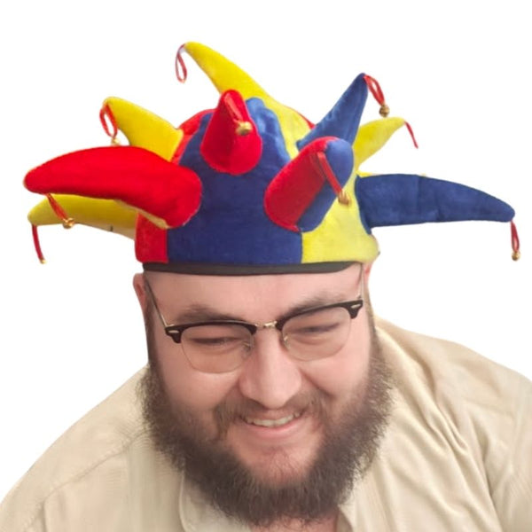 Person wearing a colorful jester hat on a white background