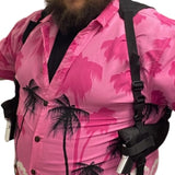 Person wearing a pink shirt with black palm tree pattern and black double shoulder holster