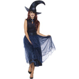 Woman wearing a witch costume with a pointed hat and long dark blue dress on a white background