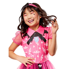Child model wearing a pink Monster High Draculaura costume with satin bodice, printed white bats, and a pink collar.