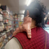 Image of the fake hand Halloween prop placed on an adult’s shoulder, showing realistic size and stitched detail for a creepy, lifelike effect.