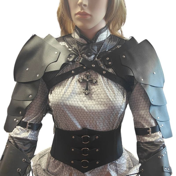 Black and silver gothic plate armor costume set on a mannequin, featuring layered shoulder armor, a cross pendant, chain details, and a corset-style waist belt.