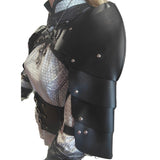 Black faux leather armor shoulder guards with silver rivets, shown on a mannequin torso wearing a patterned silver and black top against a white background.
