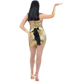 Woman wearing a gold sequin dress with black accents on a white background