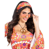 Woman wearing a colorful 1960s-themed outfit with a headband, sunglasses, and dress.