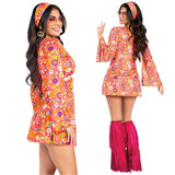 Woman wearing a colorful 1970s-themed dress with bell sleeves and pink fringed boot covers on a white background.
