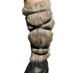 Fur-covered boot with a leather strap on a white background