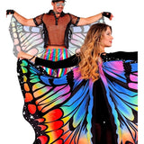 Two people wearing colorful butterfly wings on a white background