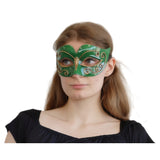 Woman wearing a green mask with gold accents 