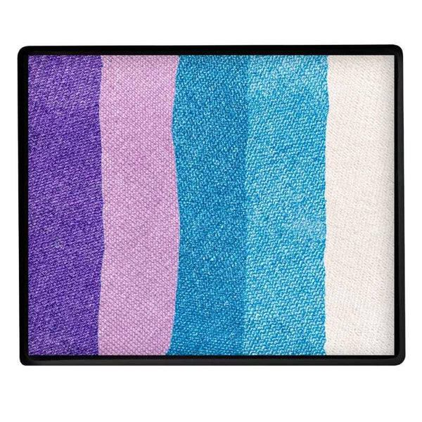 A rectangular makeup palette with five vertical stripes of pearl face paint in purple, light purple lilac, blue, light blue, and white, enclosed in a black frame.