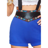 Close-up of brown lederhosen shorts with ribbon trim and decorative suspenders.