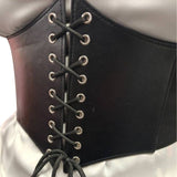 Black leather look corset belt with laces on a white background