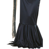 Close up of Morticia Addams black satin dress showing mermaid style skirt and jagged hemline