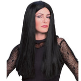 A long, straight black wig for Morticia Addams, modeled on a person wearing a black lace-sleeve top against a plain white background.