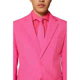 Person wearing a bright pink suit with matching shirt and tie on a white background
