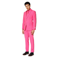 Man wearing a bright pink suit with matching tie on a white background