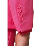 Close-up of a bright pink pantsuit with buttons on a white background