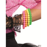 Colorful beaded bracelets on a wrist with a pink textured background