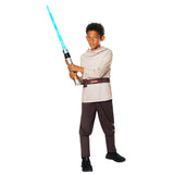 A child wearing a Star Wars Jedi costume, holding a toy lightsaber, standing against a plain white background.