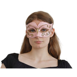 Woman wearing a pink and gold mask 